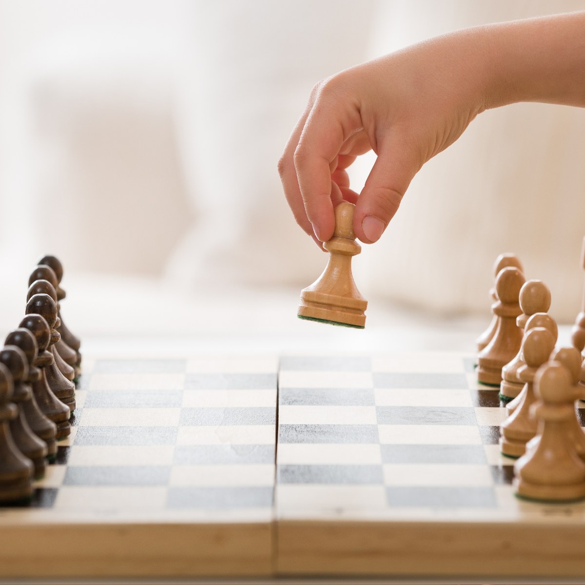 Student moving a pawn during a Think First Labs chess club session